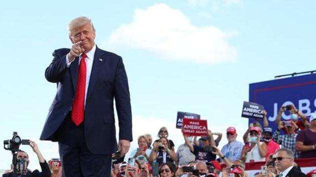 US President Donald Trump gestures in front of supporters at Basler Flight Service in Oshkosh, Wisconsin, US(Reuters)