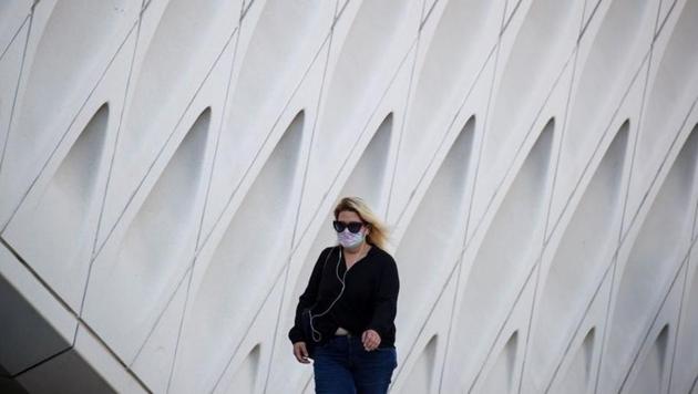 A woman wearing a face mask walks by The Broad Museum in downtown during the outbreak of the coronavirus disease (Covid-19), in Los Angeles, California,(REUTERS)