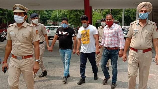 The accused in police custody at the Sector 17 police station in Chandigarh on Tuesday. (HT Photo) The accused in police custody at the Sector 17 police station in Chandigarh on Tuesday. (HT Photo)