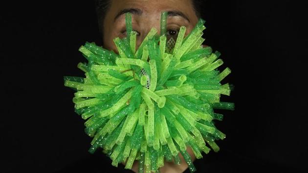 Edmond Kok, a Hong Kong theater costume designer and actor, wearing a spiky green mask which is a 3D visualisation of corona virus in Hong Kong. (AP Photo/Vincent Yu) Edmond Kok, a Hong Kong theater costume designer and actor, wearing a spiky green mask which is a 3D visualisation of corona virus in Hong Kong. (AP Photo/Vincent Yu)