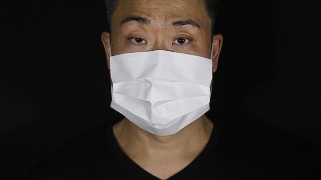 Edmond Kok, a Hong Kong theater costume designer and actor, wearing a face mask made by a white paper in Hong Kong. (AP Photo/Vincent Yu) Edmond Kok, a Hong Kong theater costume designer and actor, wearing a face mask made by a white paper in Hong Kong. (AP Photo/Vincent Yu)