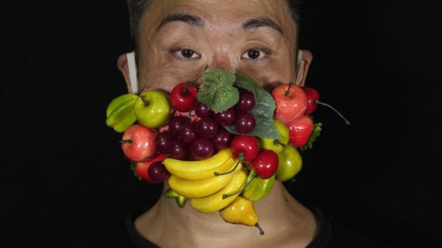 Edmond Kok, a Hong Kong theater costume designer and actor, wearing a face mask decorated with many different fruits in Hong Kong. (AP Photo/Vincent Yu) Edmond Kok, a Hong Kong theater costume designer and actor, wearing a face mask decorated with many different fruits in Hong Kong. (AP Photo/Vincent Yu)
