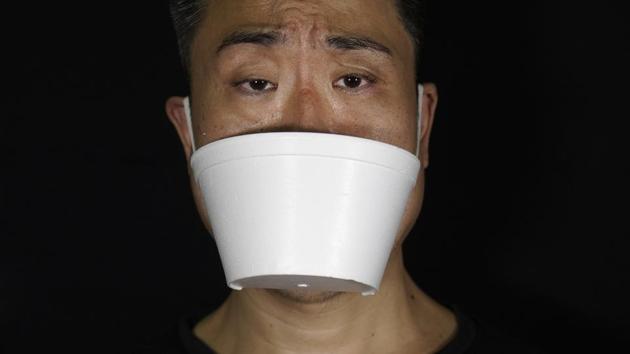 Edmond Kok, a Hong Kong theater costume designer and actor, wearing a face mask made from takeaway container in Hong Kong. (AP Photo/Vincent Yu) Edmond Kok, a Hong Kong theater costume designer and actor, wearing a face mask made from takeaway container in Hong Kong. (AP Photo/Vincent Yu)