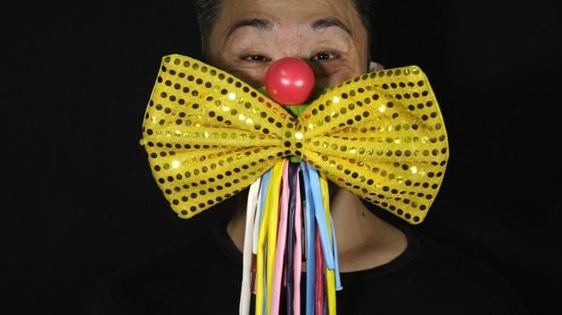 Edmond Kok, a Hong Kong theater costume designer and actor, wearing a face mask designed as traditional clown face and bow tie costume in Hong Kong. (AP Photo/Vincent Yu) Edmond Kok, a Hong Kong theater costume designer and actor, wearing a face mask designed as traditional clown face and bow tie costume in Hong Kong. (AP Photo/Vincent Yu)