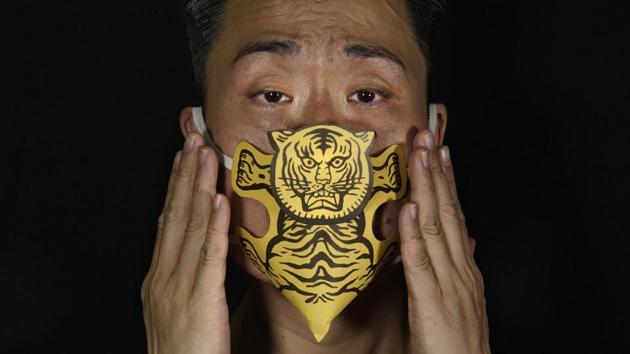 Edmond Kok, a Hong Kong theater costume designer and actor, wearing a face mask made by a paper tiger use for villain hitting in Hong Kong Thursday, Aug. 6, 2020. (AP Photo/Vincent Yu) Edmond Kok, a Hong Kong theater costume designer and actor, wearing a face mask made by a paper tiger use for villain hitting in Hong Kong Thursday, Aug. 6, 2020. (AP Photo/Vincent Yu)