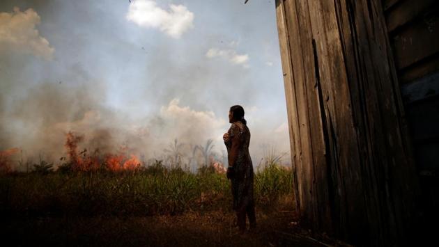 Miraceli de Oliveira looks on as the fire approaches her house in the State of Rondonia on August 16. Deforestation has risen 34.5% in the 12 months through July, compared to a year earlier, Reuters reported. (Ueslei Marcelino / REUTERS)
