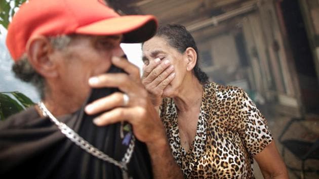 Siblings Rosalino de Oliveira and Miraceli de Oliveira shield their face from the suffocating smoke as the fire approaches their house near Porto Velho, in the State of Rondonia on August 16. “Every year I suffer from this. Nobody knows who does this. They come and burn everything and run away,” Rosalino told Reuters. (Ueslei Marcelino / REUTERS)