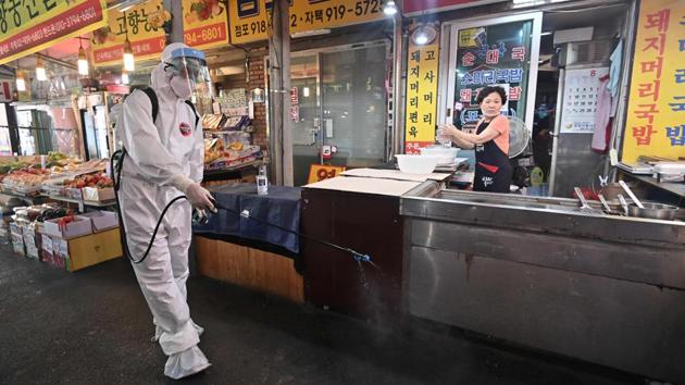 A health official wearing protective gear sprays disinfectant at a market near the Sarang Jeil Church, a new coronavirus infection cluster, in Seoul on August 18. The outbreak at the Seoul church has revived fears seen in February when authorities struggled to contain an outbreak that emerged in a secretive Christian sect in the city of Daegu and became the country’s deadliest cluster. (Jung Yeon-je / AFP)