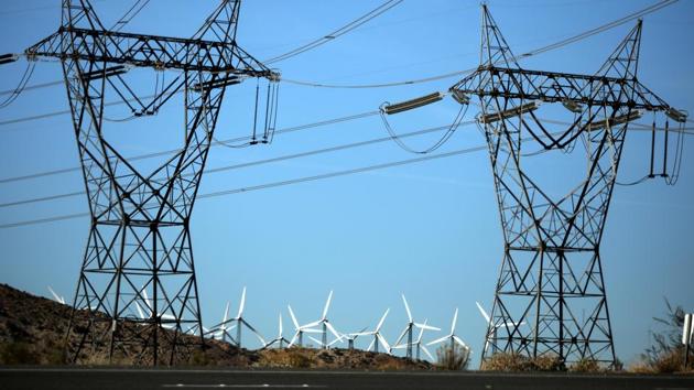 Windmills are seen behind electricity pylons in Palm Springs, California, US.(REUTERS)