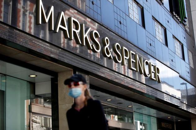A woman walks past a Marks & Spencer store at Oxford Street, amid the outbreak of the coronavirus disease (Covid-19), in London, Britain.(REUTERS)