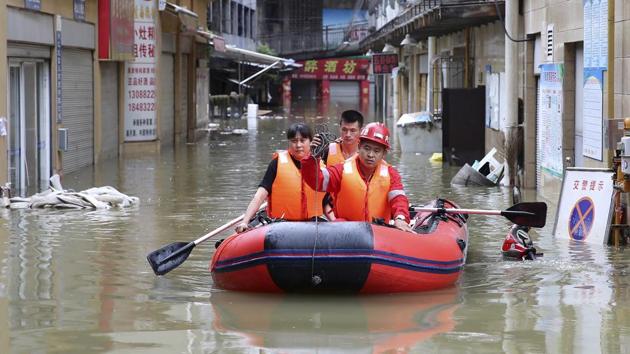 Video footage showed soldiers evacuating residents wearing lifejackets -- many of them elderly -- from Fengzhou county opposite the statue, helping them climb into a boat.(AP Photo) Video footage showed soldiers evacuating residents wearing lifejackets -- many of them elderly -- from Fengzhou county opposite the statue, helping them climb into a boat.(AP Photo)