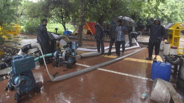 Public Works Department (PWD) workers clear out a water at Ring Road near WHO building in New Delhi on August 19. While no respite from rain was in sight till much later in the day, the PWD and civic bodies told HT that adequate arrangements were in place and water accumulated on main roads and streets was being pumped out. (Sonu Mehta / HT Photo) Public Works Department (PWD) workers clear out a water at Ring Road near WHO building in New Delhi on August 19. While no respite from rain was in sight till much later in the day, the PWD and civic bodies told HT that adequate arrangements were in place and water accumulated on main roads and streets was being pumped out. (Sonu Mehta / HT Photo)