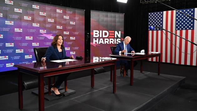 (FILES) In this file photo taken on August 14, 2020 Democratic presidential nominee, former US Vice President Joe Biden (R), and vice presidential running mate, US Senator Kamala Harris, sign required documents for receiving the Democratic nomination for President and Vice President, in Wilmington, Delaware.(AFP)