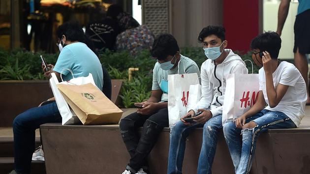 People seen wearing face masks at Palladium mall in Mumbai on August 16. Health experts told HT that the main reason for continuing surge in infections is the rise in cases in semi-urban and rural areas since the easing of lockdown restrictions. (Punit Pranjpe / AFP)