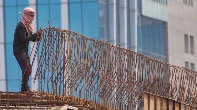 A labourer works at Shankar Chowk elevated U-turn flyover during the ongoing Covid-19 lockdown in Gurugram on June 13, 2020.(PTI Photo)