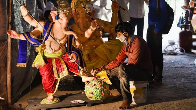 An artist works on an idol of Hindu deity Ganesha slaying a structure resembling to coronavirus with a trident, ahead of the upcoming Ganesh Chaturthi festival at Lower Parel in Mumbai on August 18. According to the coronavirus tracking website Worldometers, Maharashtra’s Covid-19 tally overtook South Africa’s numbers as the numbers reached 615,477 on August 19. (Kunal Patil / PTI)