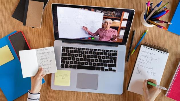 High angle view of video conference with teacher on laptop at home.(Getty Images/iStockphoto) High angle view of video conference with teacher on laptop at home.(Getty Images/iStockphoto)