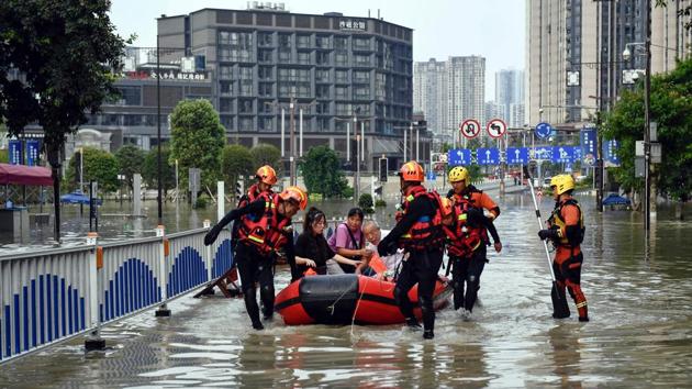 Rescuers evacuate residents on a flooded street in China’s southwestern Chongqing on August 19. Xinhua also issued a warning on August 19 that the floodwaters were expected to hit the downstream metropolis of Chongqing later this week. However, unusual rainfall patterns have fast-tracked the flooding. (AFP)