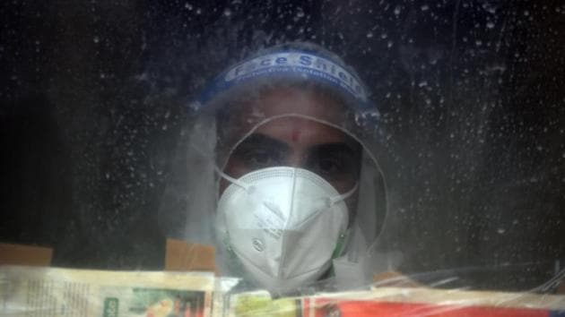 A health worker seen behind a protective screen during a sample collection drive for coronavirus testing at Shastri Park Dispensary in New Delhi on August 19. With 983 deaths between August 20 and 21 morning, the number of Covid-19 fatalities reached 54,849. (Raj K Raj / HT Photo) A health worker seen behind a protective screen during a sample collection drive for coronavirus testing at Shastri Park Dispensary in New Delhi on August 19. With 983 deaths between August 20 and 21 morning, the number of Covid-19 fatalities reached 54,849. (Raj K Raj / HT Photo)