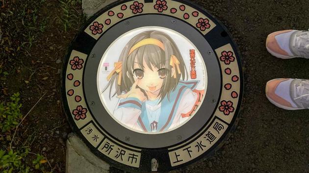 A passerby stands next to an illuminated manhole cover.(REUTERS) A passerby stands next to an illuminated manhole cover.(REUTERS)