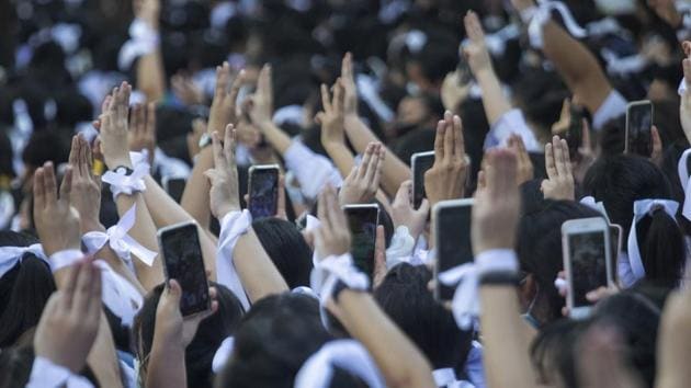 Pro-democracy students wearing white ribbons, raise a three-finger symbol of resistance salute during a protest rally in front of Education Ministry in Bangkok on August 19. Some students also wore white ribbons to show their support for protesters, who seek Chan-ocha’s departure, a new constitution and an end to the harassment of activists. According to Reuters, some students have also called for reforms to the monarchy, once a taboo subject. (Sakchai Lalit / AP)