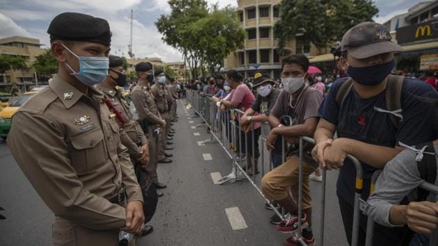 Pro-democracy protesters stand in front of police during a protest in Bangkok on August 16. The anti-government protest in Thailand drew at least 10,000 people on August 16, police told AFP. The largest political demonstration the kingdom has seen in years as a pro-democracy movement gathers steam, wrote AFP. (Sakchai Lalit / AP)