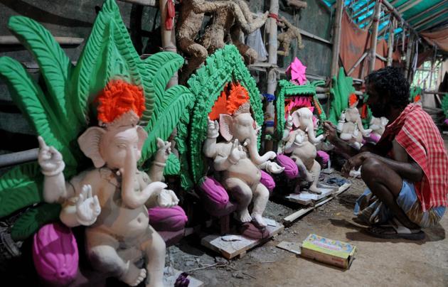 Chandigarh, India - August 17, 2020: A craftsman paints clay idols of Lord Ganesha ahead of Ganesh Chaturthi, at Kaliwari, in Chandigarh, India, on Monday, August 17, 2020. (Photo by Keshav Singh/Hindustan Times) Chandigarh, India - August 17, 2020: A craftsman paints clay idols of Lord Ganesha ahead of Ganesh Chaturthi, at Kaliwari, in Chandigarh, India, on Monday, August 17, 2020. (Photo by Keshav Singh/Hindustan Times)