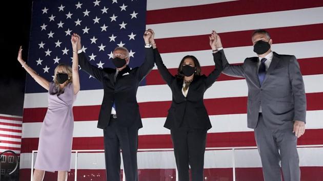 Former Vice President Joe Biden, Democratic presidential nominee, second left, wife Jill Biden, left, Senator Kamala Harris, Democratic vice presidential nominee, second right, and husband Douglas Emhoff, wear protective masks while holding hands outside the Chase Center during the Democratic National Convention in Wilmington. (Bloomberg) Former Vice President Joe Biden, Democratic presidential nominee, second left, wife Jill Biden, left, Senator Kamala Harris, Democratic vice presidential nominee, second right, and husband Douglas Emhoff, wear protective masks while holding hands outside the Chase Center during the Democratic National Convention in Wilmington. (Bloomberg)