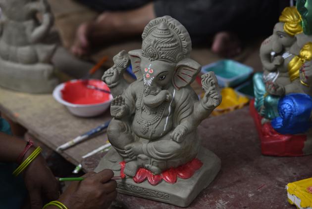 New Delhi, India - August 18, 2020: A woman paints an idol of Lord Ganesha in her workshop to ready it for sale ahead of Ganesh Chaturthi festival, at Sarojini Nagar, in New Delhi, India, on Tuesday, August 18, 2020. (Photo by Sanjeev Verma/ Hindustan Times) (Sanjeev Verma/HT PHOTO) New Delhi, India - August 18, 2020: A woman paints an idol of Lord Ganesha in her workshop to ready it for sale ahead of Ganesh Chaturthi festival, at Sarojini Nagar, in New Delhi, India, on Tuesday, August 18, 2020. (Photo by Sanjeev Verma/ Hindustan Times) (Sanjeev Verma/HT PHOTO)