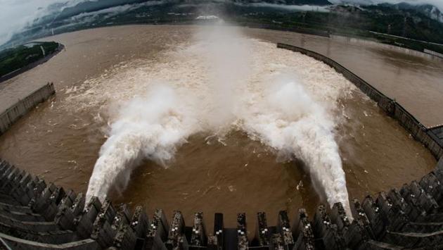 The Three Gorges Dam on the Yangtze River discharges water to lower the water level in the reservoir following near maximum reservoir levels, in Yichang on August 17. Flooding has left more than 200 people dead or missing in China this year and caused $26 billion worth of damage and left 63 million people affected, Reuters reported. (China Daily via REUTERS)