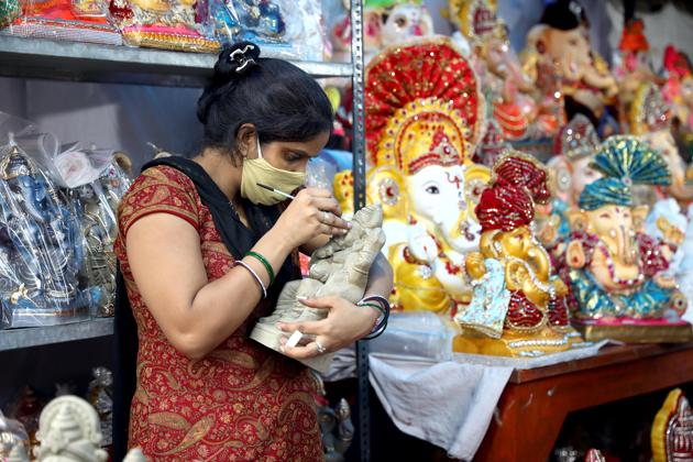New Delhi, Aug 21 (ANI): A woman gives a final coating on an idol of Ganesha, the deity of prosperity, ahead of the Ganesh Chaturthi Festival, in New Delhi on Friday. (ANI Photo) (ANI) New Delhi, Aug 21 (ANI): A woman gives a final coating on an idol of Ganesha, the deity of prosperity, ahead of the Ganesh Chaturthi Festival, in New Delhi on Friday. (ANI Photo) (ANI)
