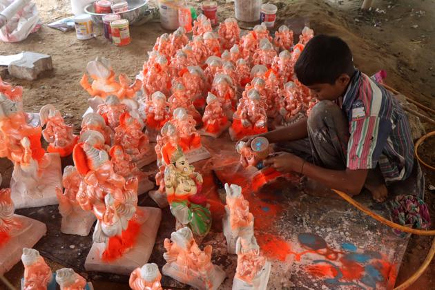 Rohtak, India - August 19, 2020: A child giving final touches to Lord Ganesha idols ahead of Ganesh Chaturthi festival, in Rohtak, Haryana, India, on Wednesday, August 19, 2020. (Photo by Manoj Dhaka / Hindustan Times) Rohtak, India - August 19, 2020: A child giving final touches to Lord Ganesha idols ahead of Ganesh Chaturthi festival, in Rohtak, Haryana, India, on Wednesday, August 19, 2020. (Photo by Manoj Dhaka / Hindustan Times)