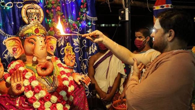 A priest performs 'aarti' in front of an idol of Lord Ganesh on the eve of Ganesh Chaturthi festival, at Thali Sree Maha Ganapathi Balasubramanya Temple in Kozhikode on Friday.(PTI Photo)