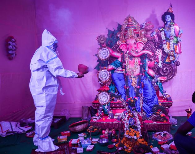 Kolkata: A devotee wearing a PPE kit offers prayers at a community puja pandal on the occasion of Ganesh Chaturthi festival, amid the ongoing coronavirus pandemic, in Kolkata, Saturday, Aug. 22, 2020. (PTI)