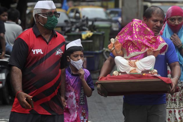 Devotees wearing face masks carry an idol of elephant-headed Lord Ganesha to take home for worship during Ganesh Chaturthi festival celebrations in Mumbai, India, Saturday, Aug. 22, 2020. (AP) Devotees wearing face masks carry an idol of elephant-headed Lord Ganesha to take home for worship during Ganesh Chaturthi festival celebrations in Mumbai, India, Saturday, Aug. 22, 2020. (AP)
