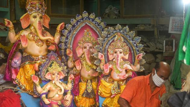 An artisan works to prepare Lord Ganesha idols on the eve of Ganesh Chaturthi festival.(PTI)