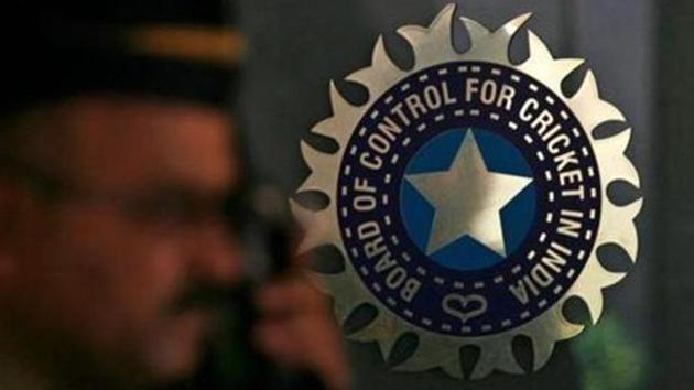 A policeman walks past a logo of the Board of Control for Cricket in India (BCCI) during a governing council meeting of the Indian Premier League (IPL) at BCCI headquarters in Mumbai.(REUTERS)