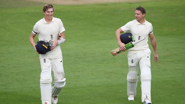 England's Zak Crawley and Jos Buttler walk off at the end of play. (REUTERS)