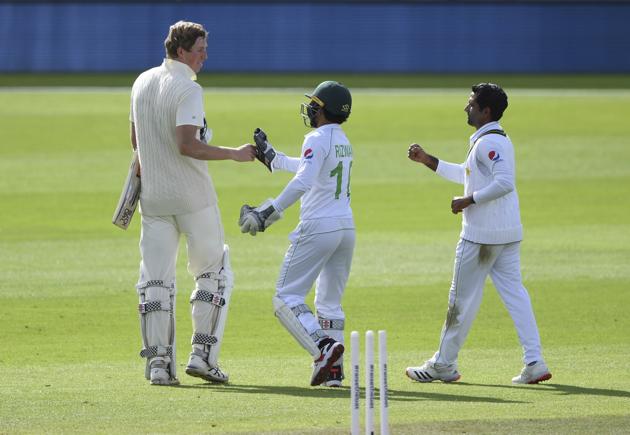 Pakistan's Asad Shafiq, right, and Mohammad Rizwan, center, greet England's Zak Crawley as he leaves the field after losing his wicket during the second day of the third cricket Test match between England and Pakistan, at the Ageas Bowl in Southampton, England, Saturday, Aug. 22, 2020. (Mike Hewitt/Pool via AP) (AP)