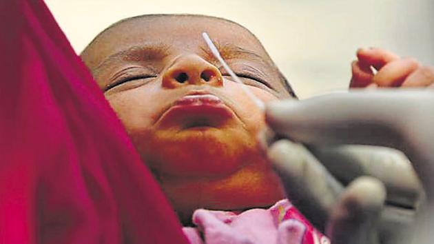 A medical worker collects a swab sample from an infant to test for Covid-19 infection.(Vipin Kumar/HT PHOTO/Representative)