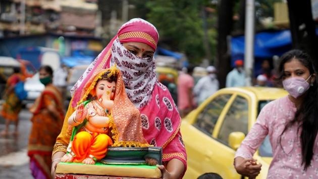 A woman carries an idol of Hindu god Ganesh to her home on the first day of the ten-day-long Ganesh Chaturthi festival, amid the coronavirus disease (Covid-19) outbreak, in Mumbai. (REUTERS) A woman carries an idol of Hindu god Ganesh to her home on the first day of the ten-day-long Ganesh Chaturthi festival, amid the coronavirus disease (Covid-19) outbreak, in Mumbai. (REUTERS)