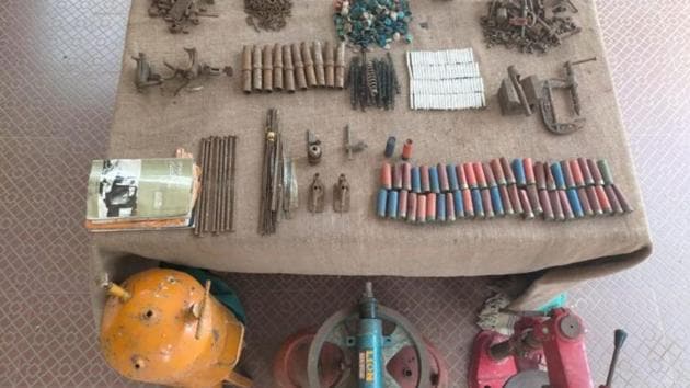 The police found forty-eight 12-Bore empty cartridge cases with caps, two 12 Bore live ammunition, 93 detonators, two gas cylinders, lathe machine, carbide gas welding cylinder, lathe accessories, iron scrap material and Maoist literature. (HT Photo)