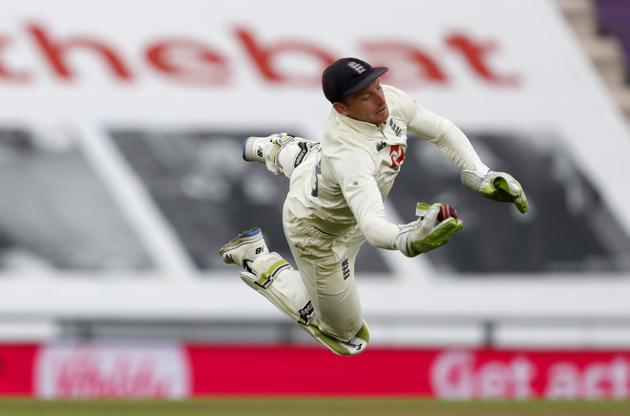 England's wicketkeeper Jos Buttler dives to take the catch to dismiss Pakistan's Shaheen Afridi during the third day of the third cricket Test match between England and Pakistan, at the Ageas Bowl in Southampton, England, Sunday, Aug. 23, 2020. (AP Photo/Alastair Grant, Pool) (AP)