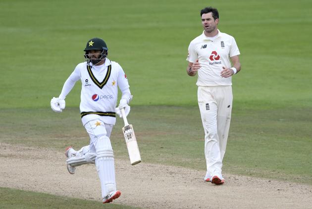 Pakistan's captain Azhar Ali, left, runs past England's James Anderson to score during the third day of the third cricket Test match between England and Pakistan, at the Ageas Bowl in Southampton, England, Sunday, Aug. 23, 2020. (Mike Hewitt/Pool via AP) (AP)