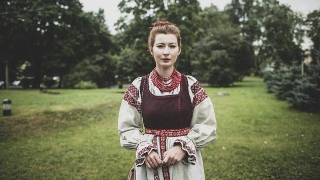 Olga Baryshnikova, 24, a student and a singer in a choir, poses for a photo wearing Belarusian national costume in Minsk on August 19. Baryshnikova took a lunch break from the nearby musical academy and came to sing to the protesters, in a gesture of support. She said she can’t sit silent at a time like this. “I hurt for Belarus,” she told AP. (Evgeniy Maloletka / AP) Olga Baryshnikova, 24, a student and a singer in a choir, poses for a photo wearing Belarusian national costume in Minsk on August 19. Baryshnikova took a lunch break from the nearby musical academy and came to sing to the protesters, in a gesture of support. She said she can’t sit silent at a time like this. “I hurt for Belarus,” she told AP. (Evgeniy Maloletka / AP)