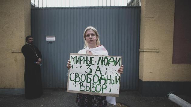 Valeria, 19, a student poses for a photo holding a handmade poster that reads “Peaceful people for the free choice” during an opposition rally in front of a detention centre in Minsk on August 17. (Evgeniy Maloletka / AP) Valeria, 19, a student poses for a photo holding a handmade poster that reads “Peaceful people for the free choice” during an opposition rally in front of a detention centre in Minsk on August 17. (Evgeniy Maloletka / AP)