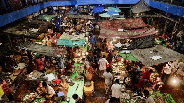 People shop for fish at a market in Kolkata, India. At a time when the economy is in a contraction phase and producers are perhaps sitting with unprecedented levels of idle capacity, households expect inflation to grow in double digits in the future. (AP) People shop for fish at a market in Kolkata, India. At a time when the economy is in a contraction phase and producers are perhaps sitting with unprecedented levels of idle capacity, households expect inflation to grow in double digits in the future. (AP)