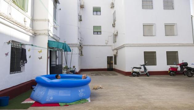 Conchi Moreno and Juan Carlos Morales bathe in a portable plastic pool in the community association patio in Seville on Aug. 14, 2020. The pool sits next to the entrance of their flat and they decided to buy it because "we are scared to go to the public pool or the beach due to the Covid'. (AP) Conchi Moreno and Juan Carlos Morales bathe in a portable plastic pool in the community association patio in Seville on Aug. 14, 2020. The pool sits next to the entrance of their flat and they decided to buy it because "we are scared to go to the public pool or the beach due to the Covid'. (AP)
