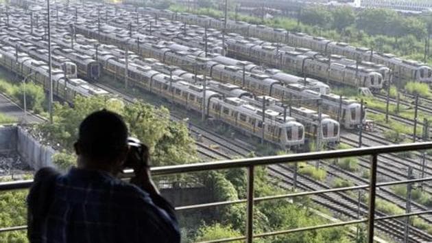 A man photographs Delhi Metro trains parked at Khyber Pass Metro Depot in New Delhi in this file photo. Metro services along with bars are likely to be allowed to resume from September 1.(Ajay Aggarwal /HT Photo)