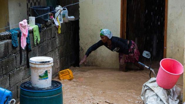 A woman tries to save items from her house in the neighborhood of Pétion ville in Haiti on August 23 during the passage of tropical storm Laura. Tropical Storm Marco -- which also churned through the Gulf of Mexico – has been downgraded from a hurricane and was forecast to hit Louisiana August 25, weakening to a tropical depression a day later. (Estailove ST-VAL / AFP)